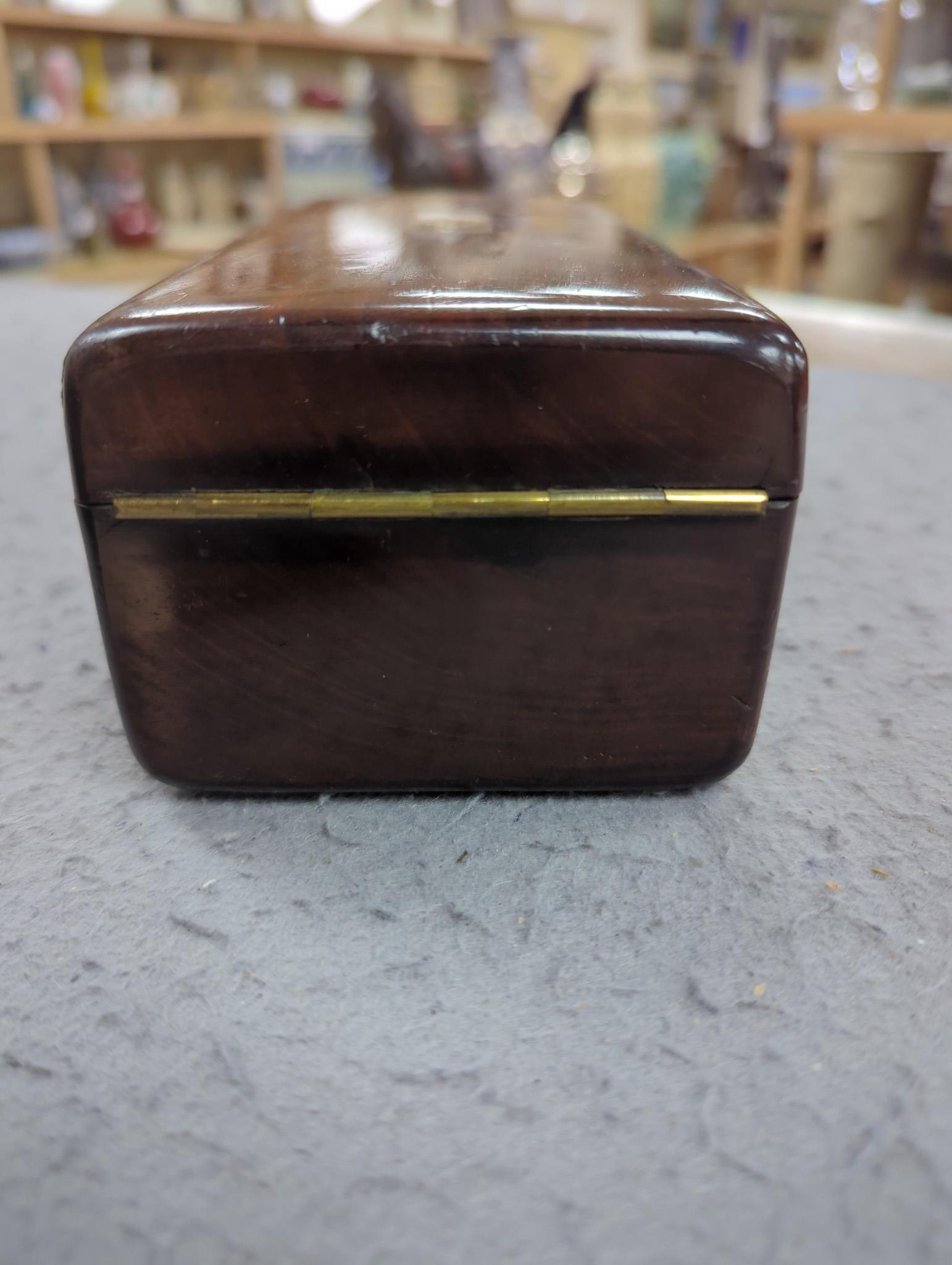 A 19th century Dutch amboyna and brass mounted tea caddy, 14 cm wide and a 19th century French mahogany box by Aucoc Aine a Paris